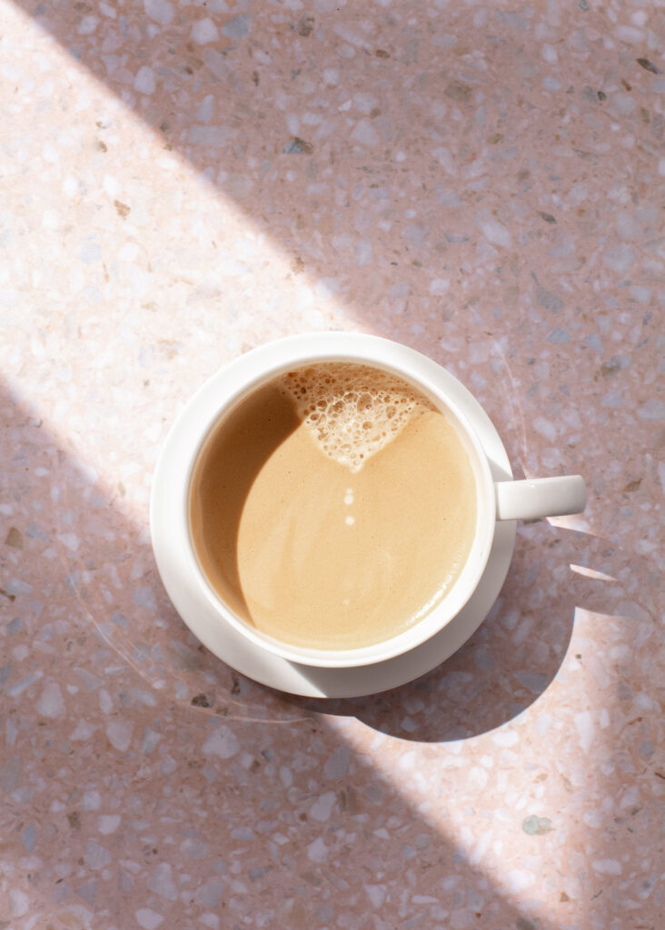 Cup of tea, top view on a pink terrazzo counter top. 