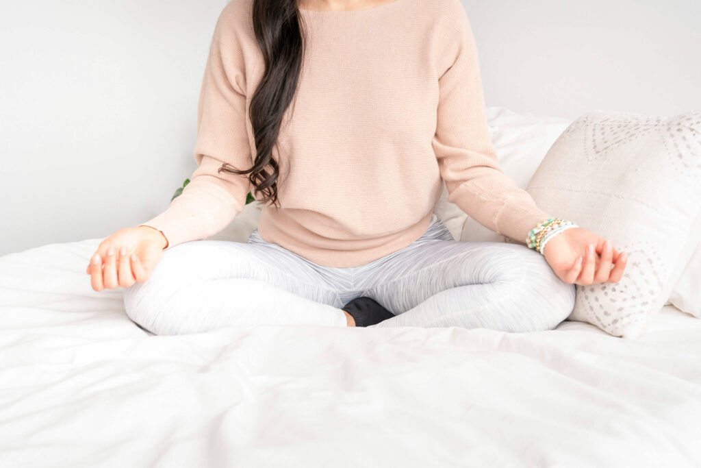 a woman in a calm meditative state finding her inner peace. Meditation is proven to calm the mind and boost clarity and productivity